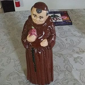 Ceramic priest holding grapes
